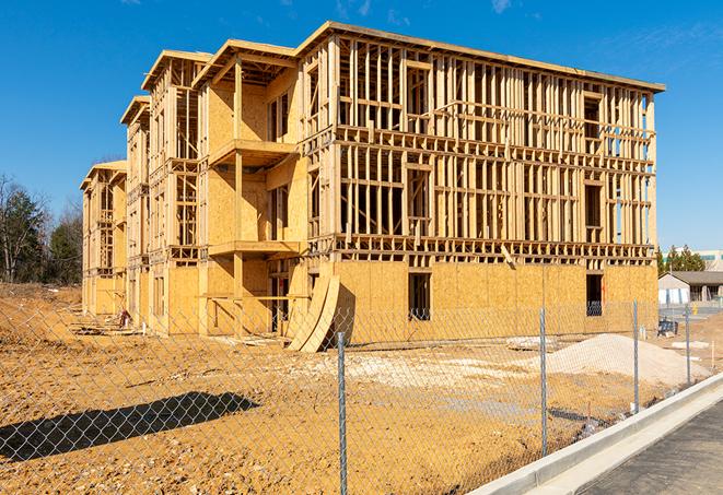 a close-up of temporary chain link fences enclosing a job site, signaling progress in the project's development in Beaverdam